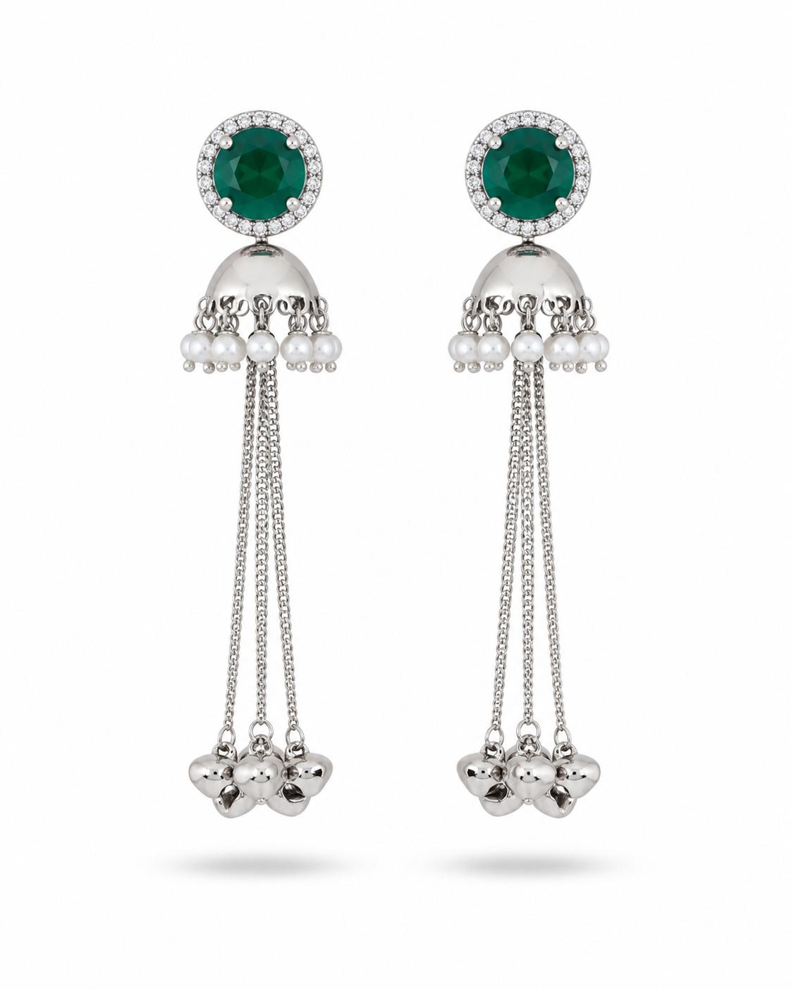 Silver jhumka tassel earrings with emerald green CZ halo top, pearl drops and long chain tassels with floral cluster ends — pair on white background