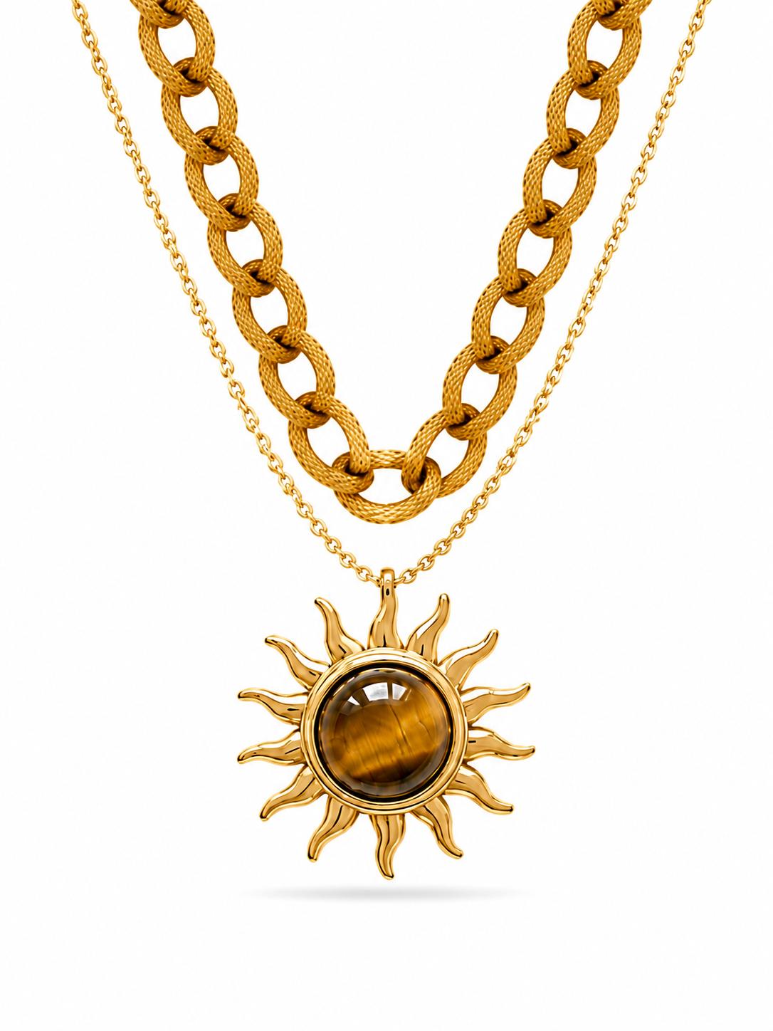 Dual-layer gold necklace set with textured curb chain and delicate cable chain featuring tiger's eye cabochon sunburst pendant — white background
