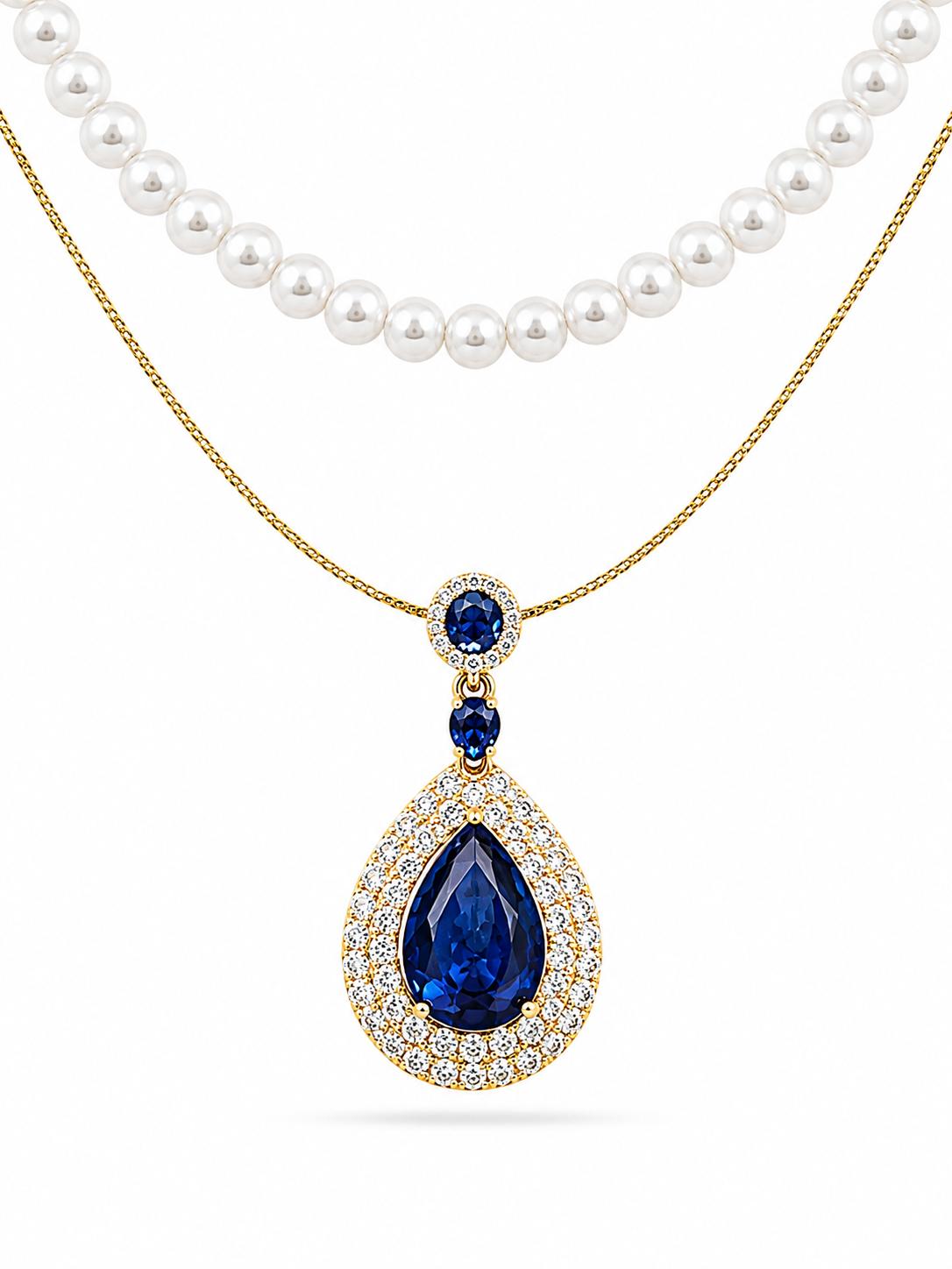 Faux pearl strand and gold-plated cable chain featuring royal blue pear-cut sapphire CZ double halo pendant with oval blue CZ bail — white background